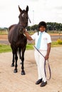 Young African boy holding the reigns of a horse