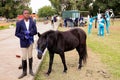 Young African boy holding the reigns of a horse