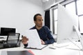 Young african business man sitting at his desk