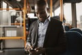 Young African businessman listening to music during his morning Royalty Free Stock Photo