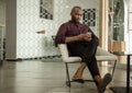 Young African businessman listening to music during his office break Royalty Free Stock Photo