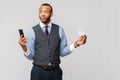 A young African businessman using his smartphone to shop online while holding his credit card Royalty Free Stock Photo