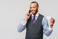 A young African businessman using his smartphone to shop online while holding his credit card Royalty Free Stock Photo