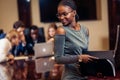 African businesswoman look at camera in boardroom with colleagues in background Royalty Free Stock Photo