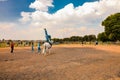 Young African children performing acrobatics on horse back