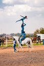 Young African children performing acrobatics on horse back