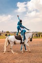 Young African children performing acrobatics on horse back