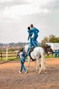 Young African children performing acrobatics on horse back