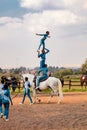 Young African children performing acrobatics on horse back