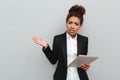 Young african confused business woman holding tablet computer. Royalty Free Stock Photo