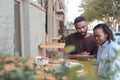 Young African couple browsing online at a sidewalk cafe Royalty Free Stock Photo