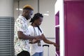 Young african couple buying train ticket at the station Royalty Free Stock Photo