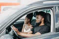 Young african couple in a car on a road trip smiling to camera Royalty Free Stock Photo