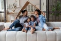 African family sit on couch under cardboard roof Royalty Free Stock Photo