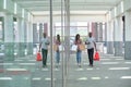 Young african couple drinking refreshing drinks and going shopping, walking outside the mall