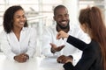 Young african couple starting family life getting keys from realtor