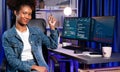 Young African IT developer presenting program and focus on camera. Tastemaker.