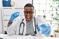 Young african doctor man holding syringe at the hospital pointing displeased and frustrated to the camera, angry and furious with Royalty Free Stock Photo