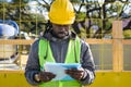 young african ethnicity man engineer at construction site with folder reading work report
