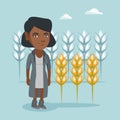 Young african farmer standing in a wheat field.