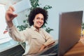 Young African female entrepreneur sitting at a desk in her home office make selfie photo Royalty Free Stock Photo