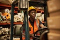 Young African female forklift operator at work in a textile storehouse Royalty Free Stock Photo