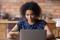 Young african female preparing to pay online using plastic card Royalty Free Stock Photo