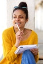 Young african female sitting outside and writing book Royalty Free Stock Photo