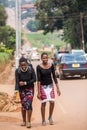 Young African female students walking on road side