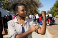 Young African girl flexing arm muscles in show of feminist power