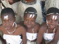 Young African girls in traditional dressing and facemarks.