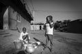 Young African girls washing the dishes in the street of Bamako i