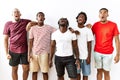 Young african group of friends standing together over isolated background angry and mad screaming frustrated and furious, shouting Royalty Free Stock Photo