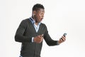 Young african guy looking at cell phone Royalty Free Stock Photo