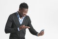 Young african guy looking at cell phone Royalty Free Stock Photo