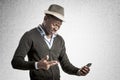 Young african guy looking at cell phone Royalty Free Stock Photo