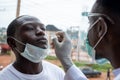 African lab scientist taking nasal sample from a man