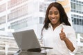 Young african lady showing thumbs up and smile with laptop computer Royalty Free Stock Photo