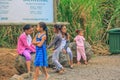 Young african local school kids girls standing and having fun together next to Casela nature park entrance .