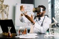 Young African male doctor, scientist, virologist, wearing virtual reality glasses for imagination, conducting research Royalty Free Stock Photo