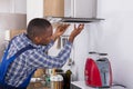African Male Fixing Kitchen Extractor Filter Royalty Free Stock Photo