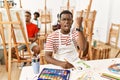Young african man at art studio annoyed and frustrated shouting with anger, yelling crazy with anger and hand raised Royalty Free Stock Photo
