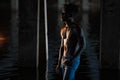 Young African man with bare-chested in jeans stands under bridge Royalty Free Stock Photo