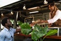 Young African man buying meal from food truck Royalty Free Stock Photo