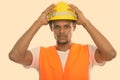 Young African man construction worker with both hands on safety helmet Royalty Free Stock Photo