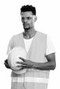 Young African man construction worker holding safety helmet while thinking Royalty Free Stock Photo