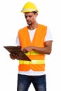 Young African man construction worker reading on clipboard Royalty Free Stock Photo