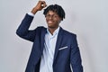 Young african man with dreadlocks wearing business jacket over white background dancing happy and cheerful, smiling moving casual Royalty Free Stock Photo