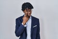 Young african man with dreadlocks wearing business jacket over white background pointing to the eye watching you gesture, Royalty Free Stock Photo