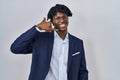 Young african man with dreadlocks wearing business jacket over white background smiling doing phone gesture with hand and fingers Royalty Free Stock Photo